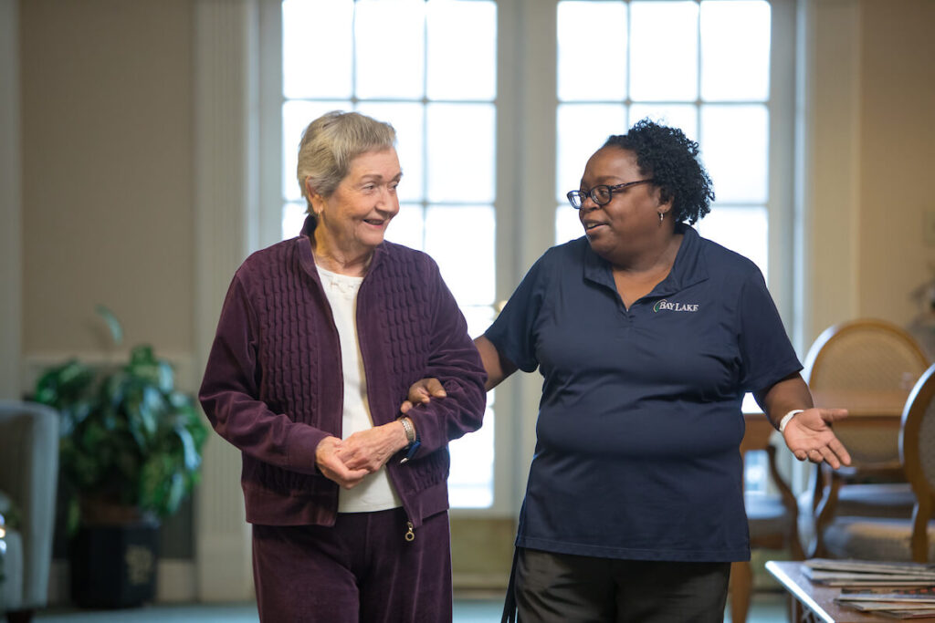 caretaker and senior in an assisted living facility